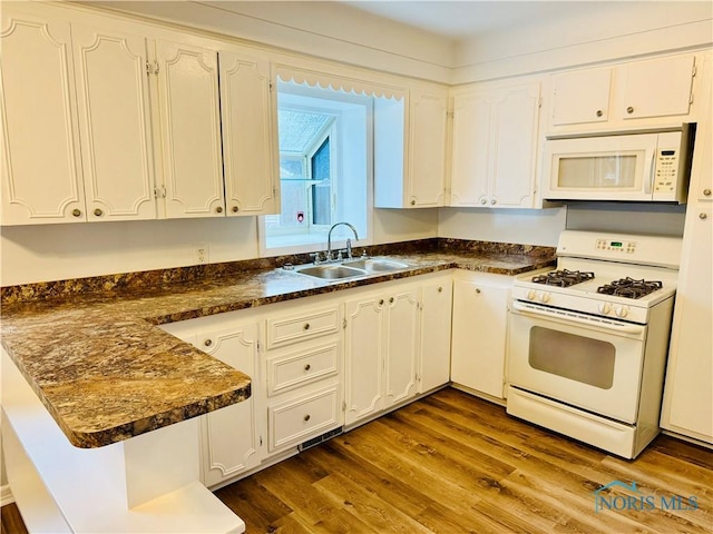 kitchen with white cabinetry, white appliances, dark wood-type flooring, and sink