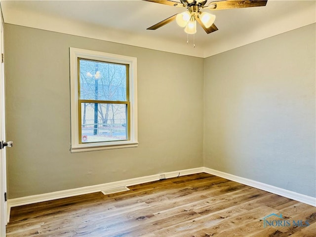 spare room with wood-type flooring and ceiling fan