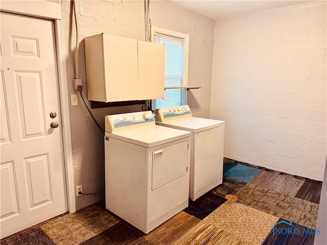 laundry area featuring washing machine and dryer and cabinets