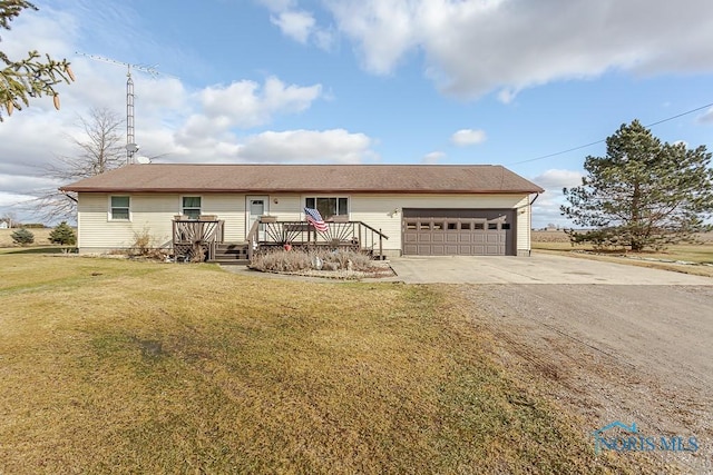 ranch-style house featuring a garage, a front yard, and a deck