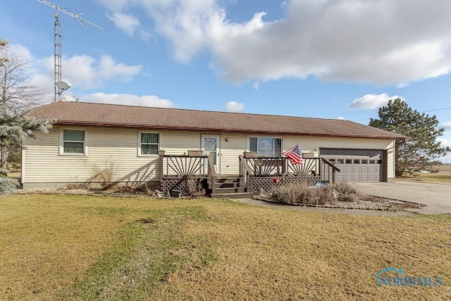 ranch-style home with a garage, a front yard, and a deck