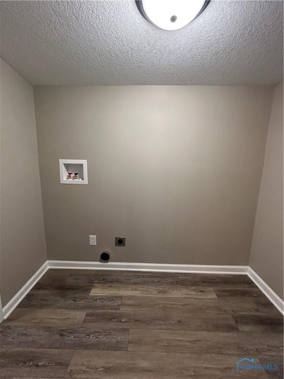 washroom with hookup for a washing machine, hookup for an electric dryer, a textured ceiling, and dark hardwood / wood-style flooring