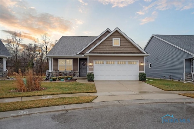 craftsman-style home featuring a yard and a garage