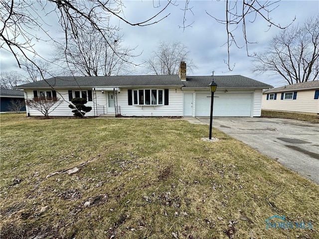 ranch-style home with a garage and a front yard