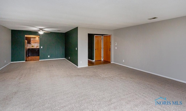 carpeted empty room with ceiling fan