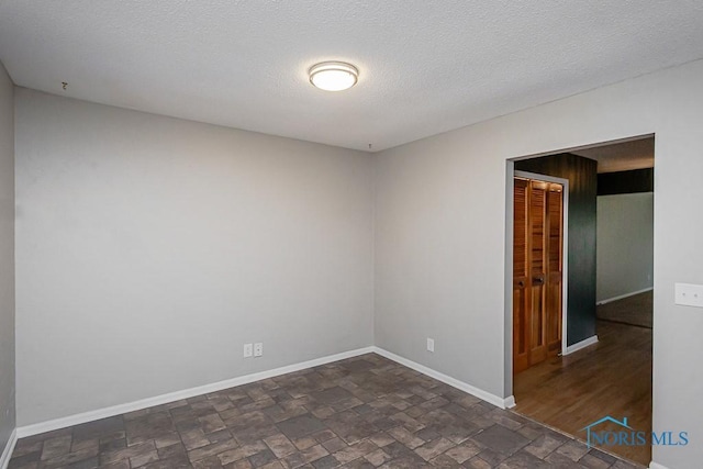 empty room with a textured ceiling