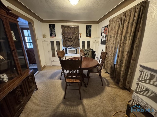 dining room featuring a textured ceiling and carpet flooring