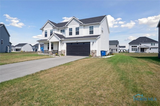 craftsman inspired home featuring a garage and a front lawn