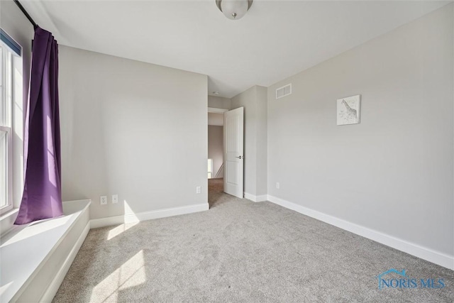 unfurnished bedroom with light colored carpet