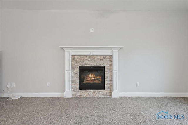 room details featuring a fireplace and carpet