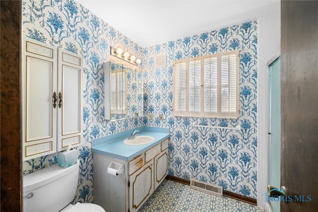 bathroom with vanity and toilet