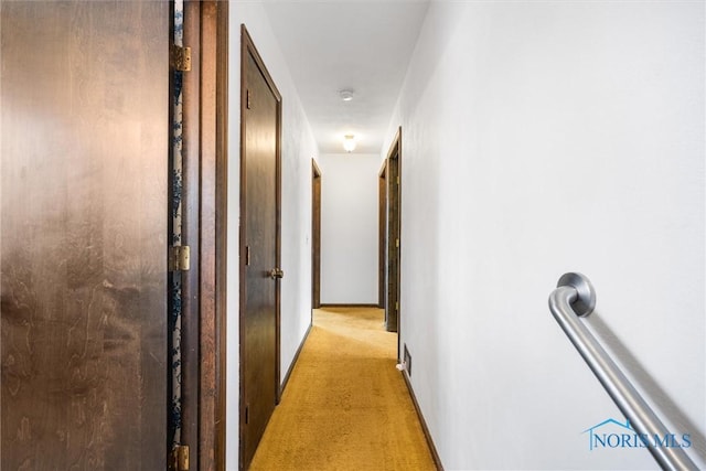 hallway with light colored carpet