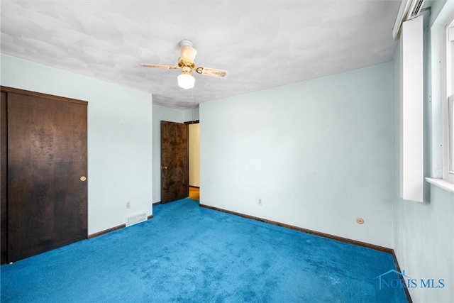 unfurnished bedroom featuring carpet floors, a closet, and ceiling fan