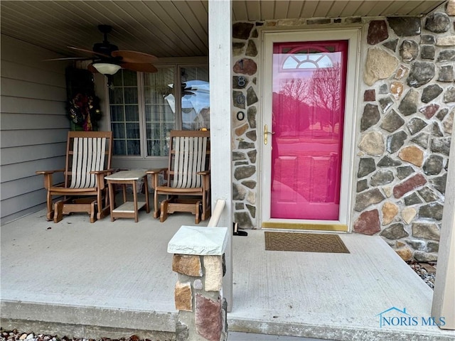 view of exterior entry with ceiling fan