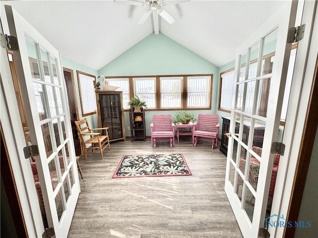 sunroom featuring ceiling fan, french doors, lofted ceiling with beams, and plenty of natural light