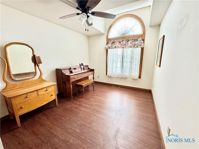 sitting room with ceiling fan and dark hardwood / wood-style floors