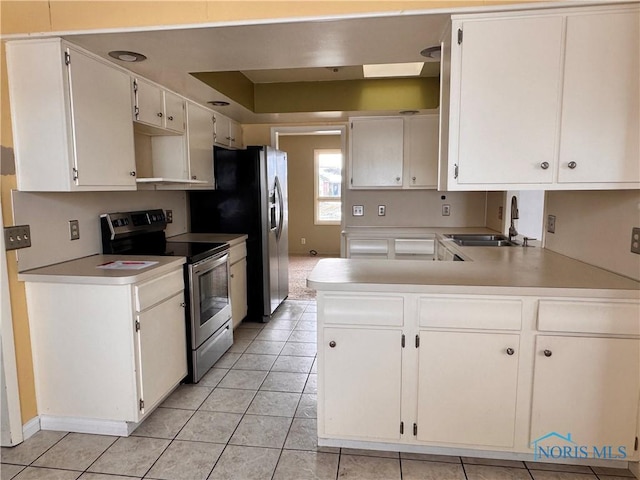 kitchen with white cabinetry, sink, stainless steel appliances, and kitchen peninsula