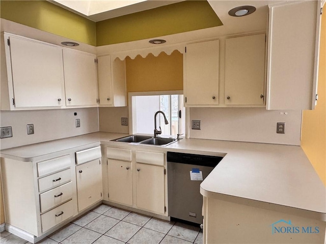 kitchen with sink, stainless steel dishwasher, light tile patterned floors, and kitchen peninsula