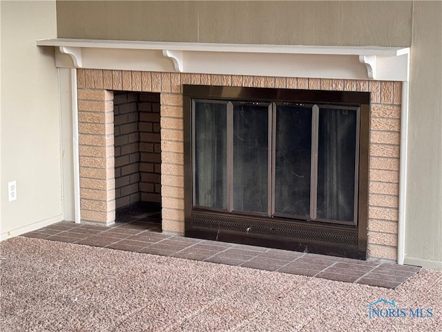 details featuring a fireplace and carpet floors