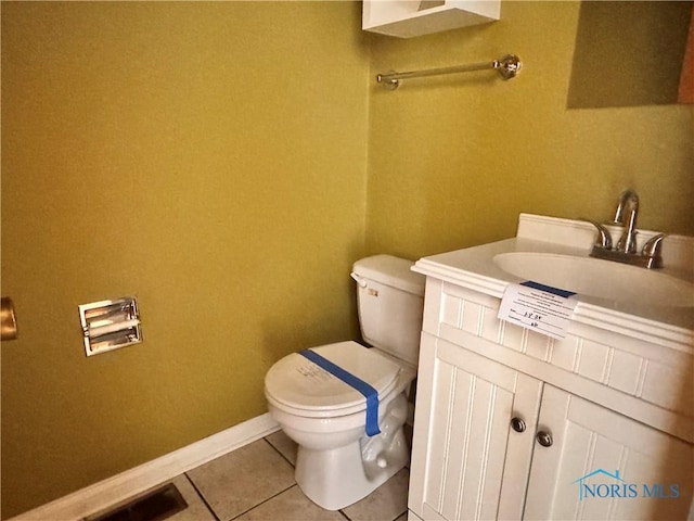 bathroom with vanity, tile patterned floors, and toilet