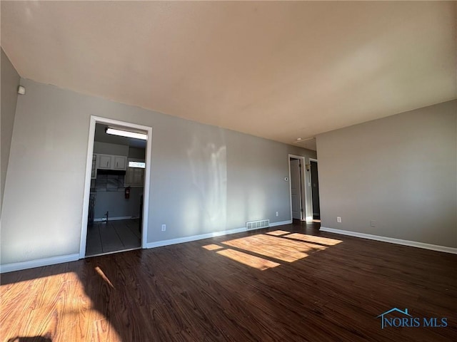 spare room with hardwood / wood-style floors