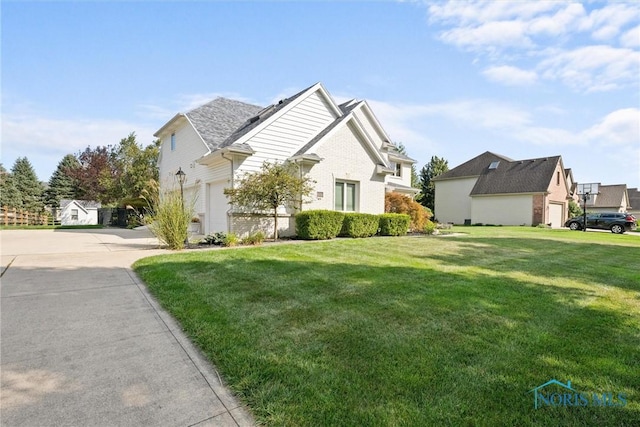 view of property exterior featuring a garage and a yard