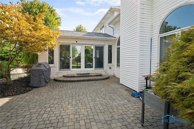 view of patio / terrace featuring a grill and french doors