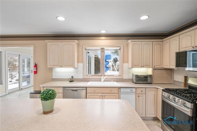 kitchen with appliances with stainless steel finishes, sink, and light tile patterned floors