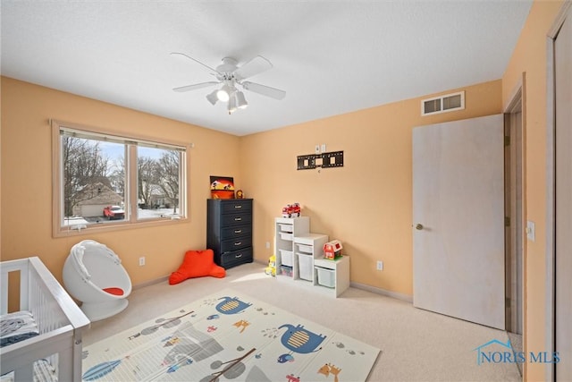 game room with light carpet and ceiling fan