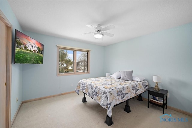 bedroom featuring light colored carpet and ceiling fan