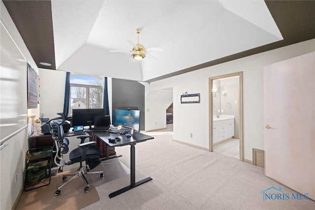 carpeted office featuring lofted ceiling and ceiling fan