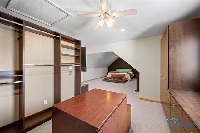 unfurnished bedroom with ceiling fan, lofted ceiling, and light carpet