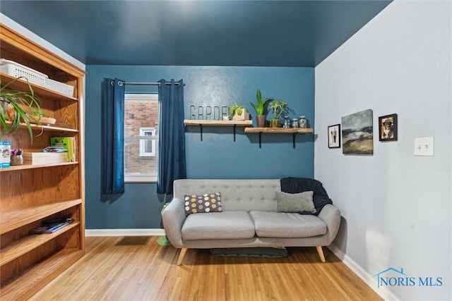 sitting room with wood-type flooring