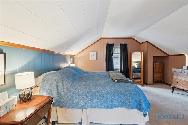 bedroom with lofted ceiling, light carpet, and wooden walls