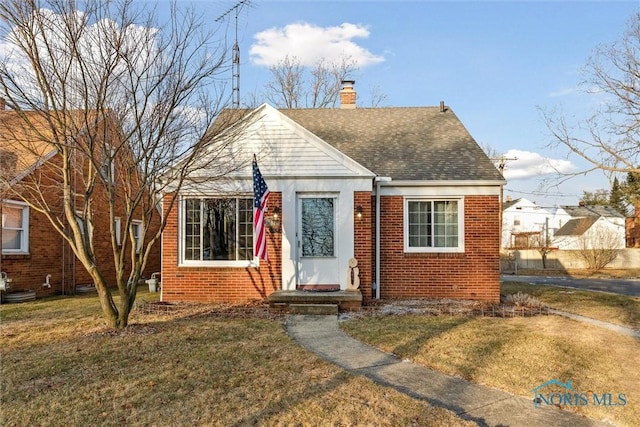 bungalow-style house featuring a front lawn