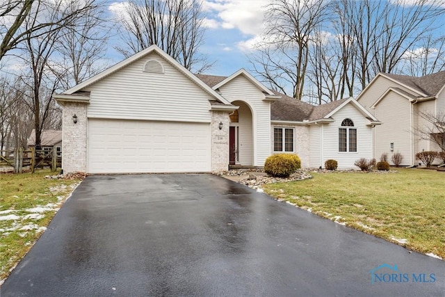 ranch-style house with a garage and a front yard