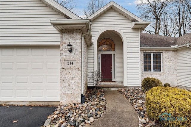 doorway to property with a garage