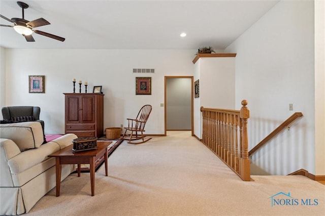 living room with ceiling fan and light carpet