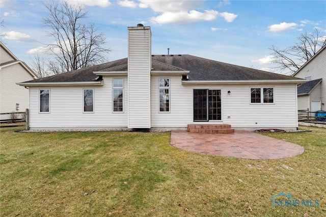 rear view of house with a lawn and a patio area