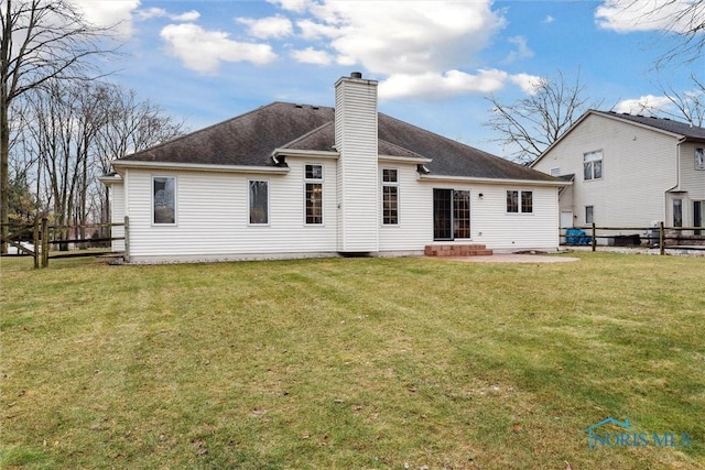 rear view of house featuring a yard