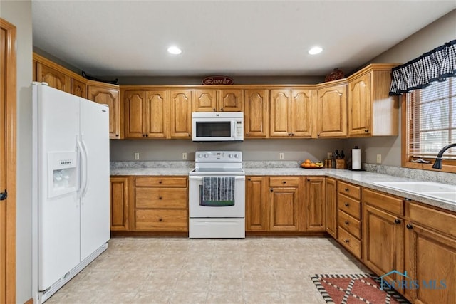 kitchen with sink and white appliances