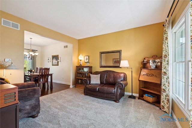 living room with a chandelier and carpet