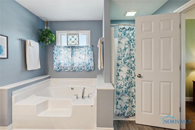 bathroom featuring hardwood / wood-style flooring and shower with separate bathtub