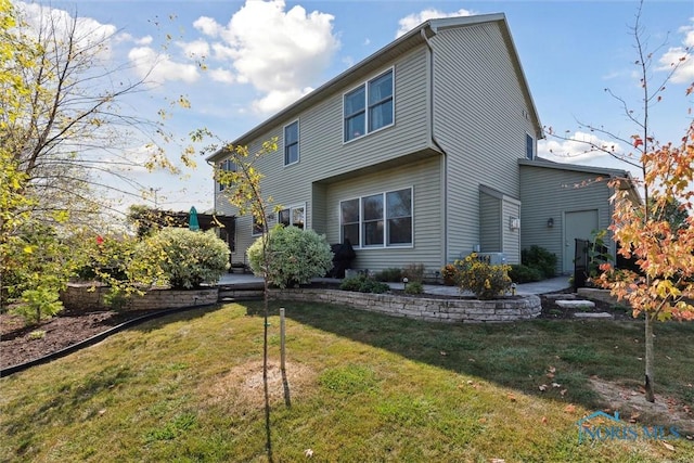 rear view of house with a yard