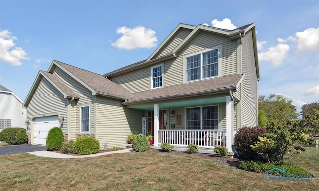 front of property with a garage, a porch, and a front yard