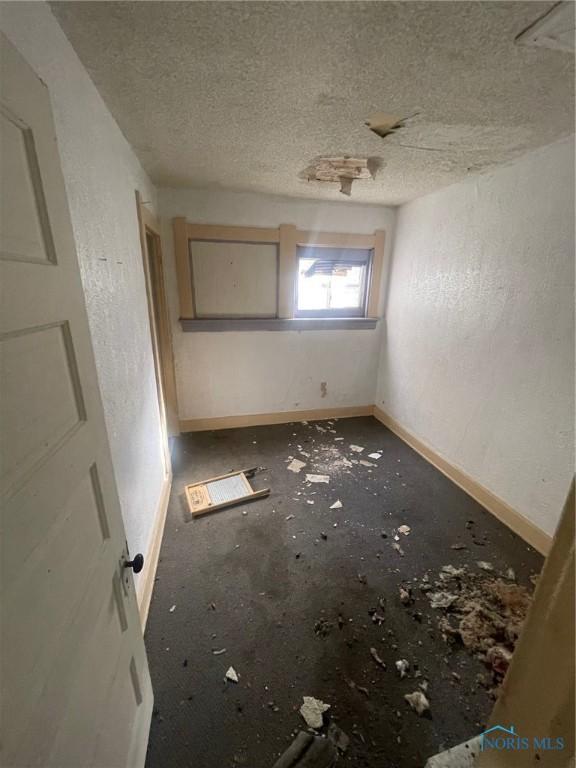 spare room with a textured ceiling