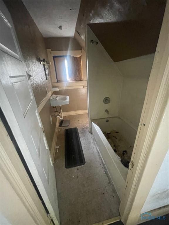 bathroom with lofted ceiling and sink