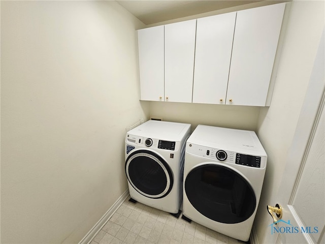 washroom featuring cabinets and separate washer and dryer