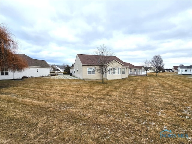 rear view of house featuring a lawn