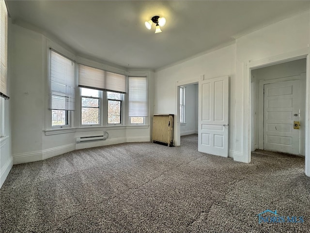 unfurnished bedroom featuring carpet and radiator heating unit